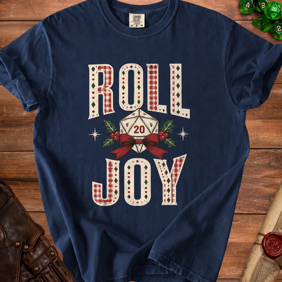 Navy t-shirt with "ROLL JOY" text and a D20 die, surrounded by holly and a bow.