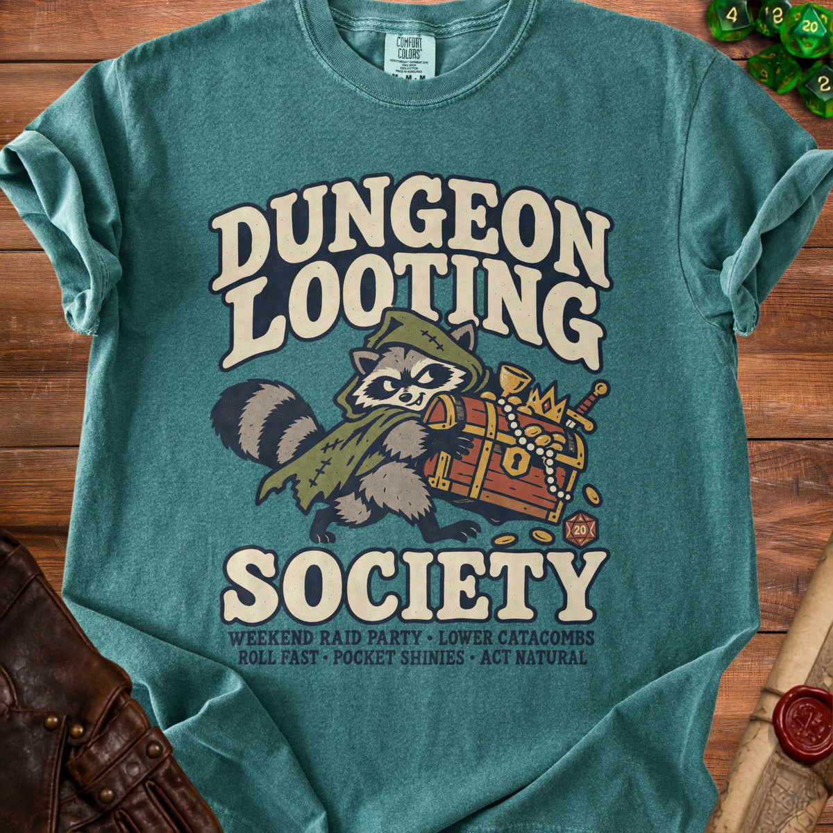 Teal t-shirt with "Dungeon Looting Society" graphic featuring a raccoon holding a treasure chest.