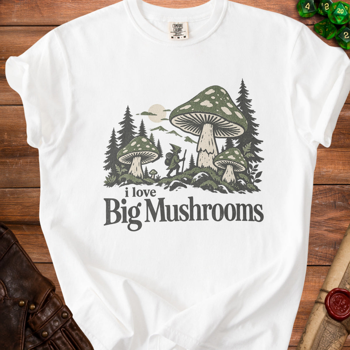 White t-shirt with graphic of a gnome and mushrooms, text "i love Big Mushrooms".
