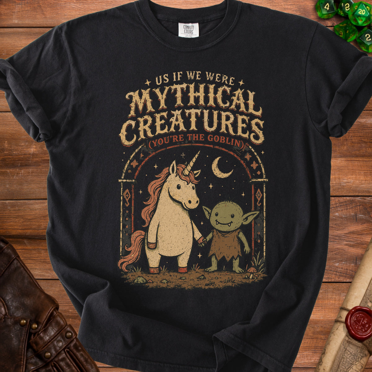Black t-shirt with unicorn and goblin graphic, reads "Us If We Were Mythical Creatures".