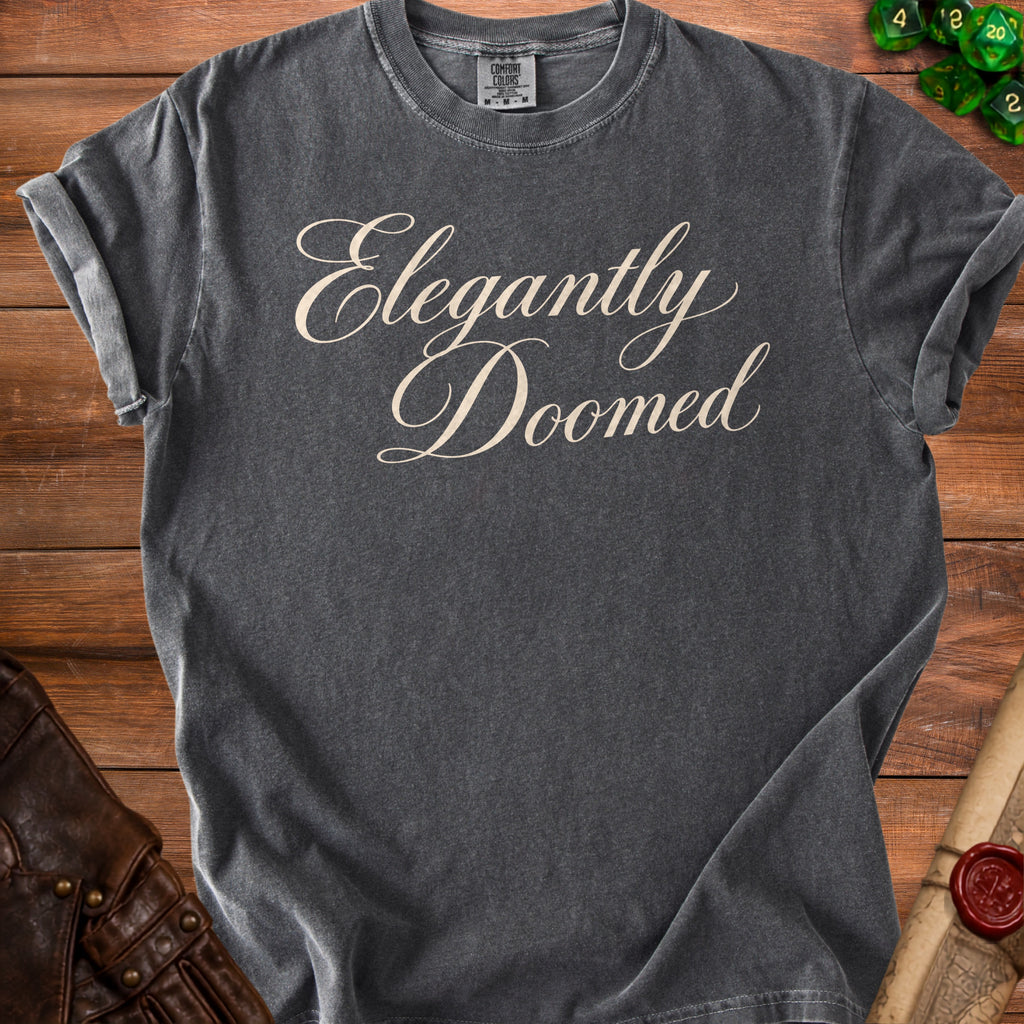 Dark grey t-shirt with "Elegantly Doomed" in cream script lettering.