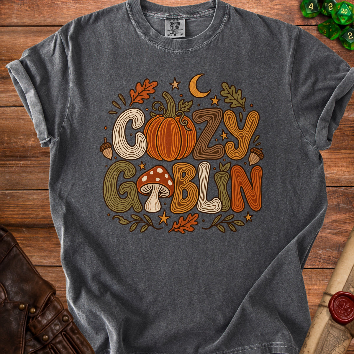 Grey t-shirt with "Cozy Goblin" text, pumpkin, mushroom, and fall leaves graphic.