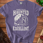 Purple t-shirt with "Tonight's forecast Haunted but the loot is Excellent" Halloween graphic.