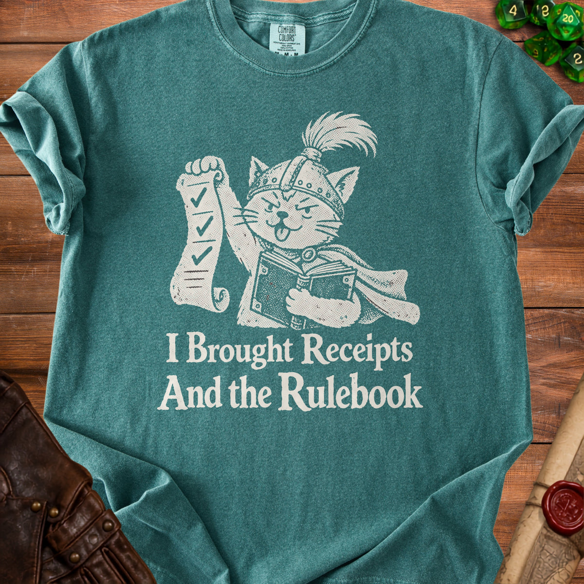 T-shirt with a graphic of a cat in armor holding a scroll and book, reading "I Brought Receipts And the Rulebook."
