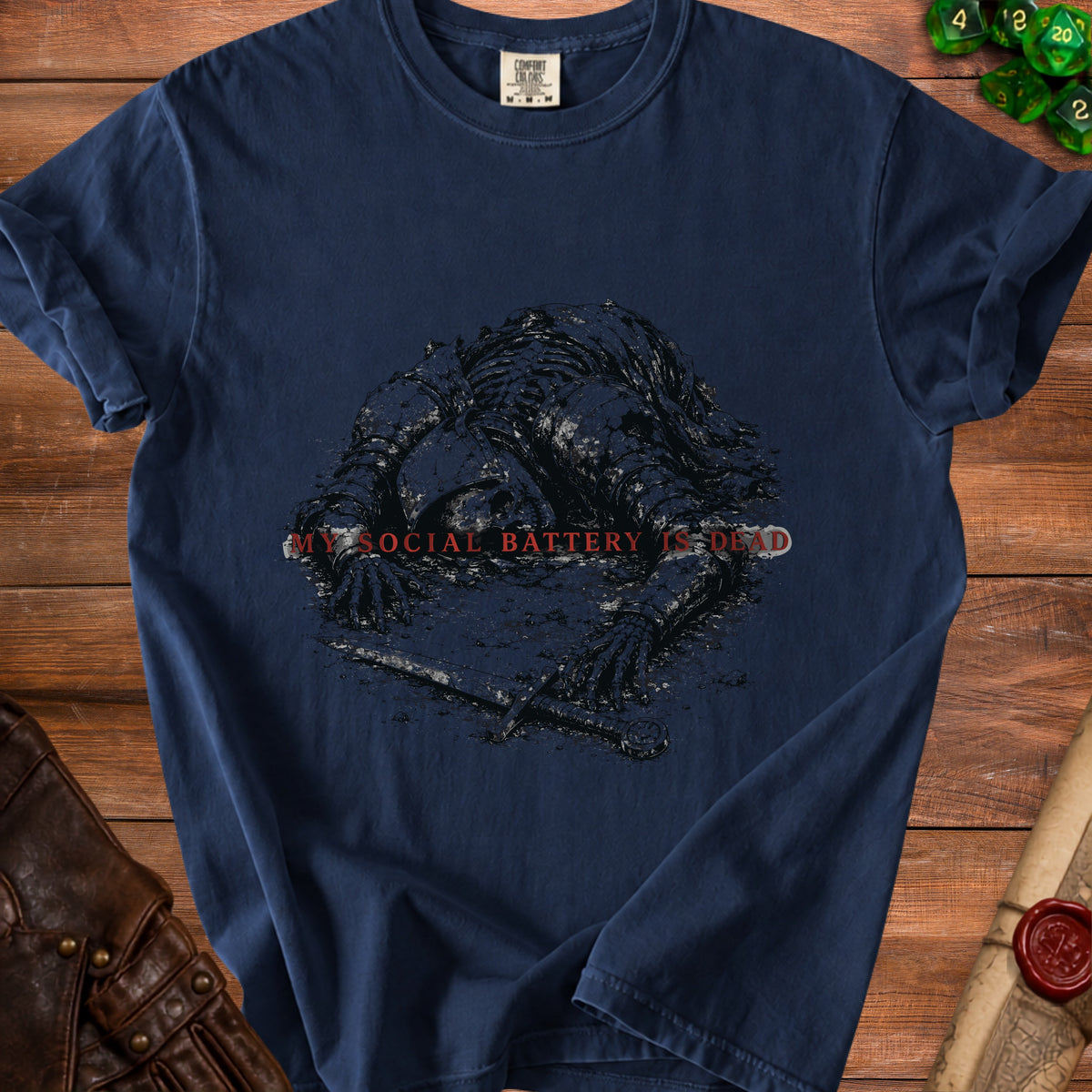 Dark blue t-shirt with a graphic of a skeleton in armor and the text "MY SOCIAL BATTERY IS DEAD".