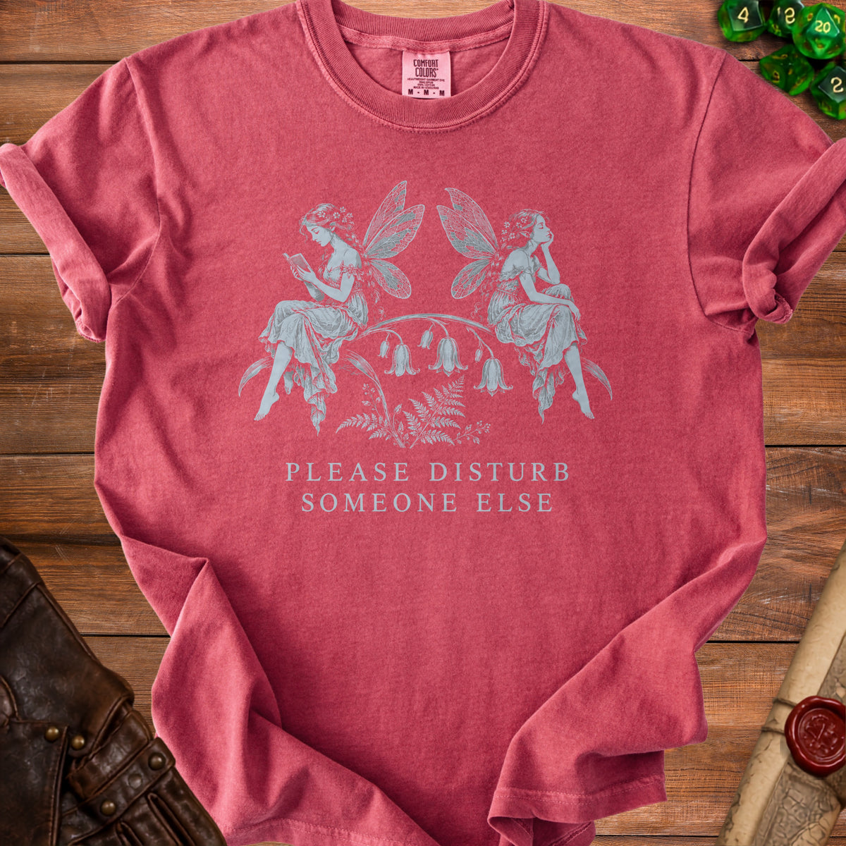 Red t-shirt with graphic of two fairies and text "PLEASE DISTURB SOMEONE ELSE."
