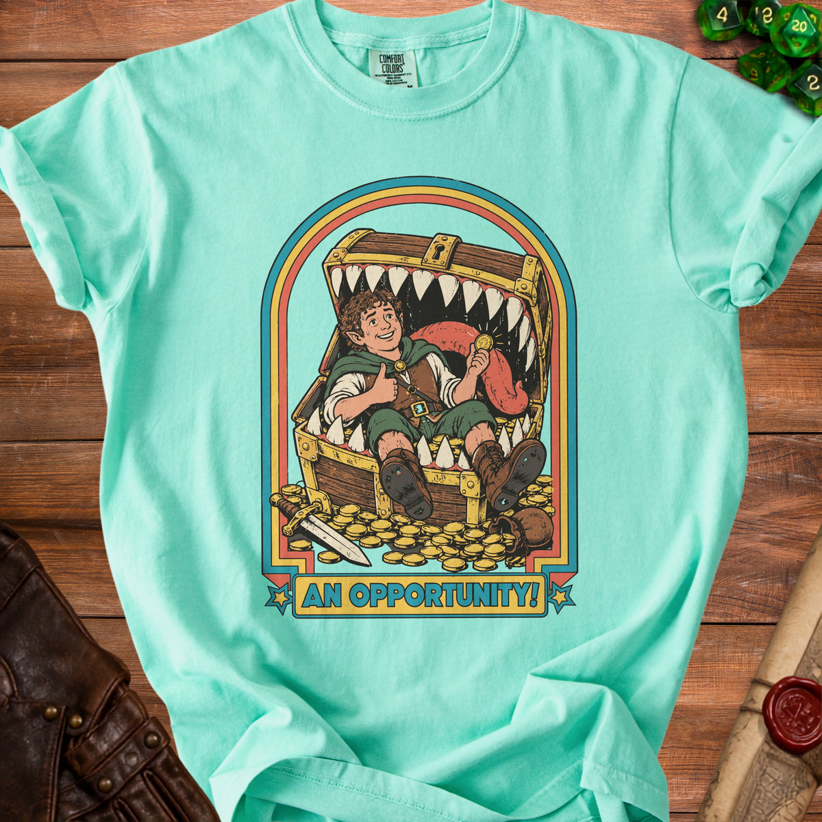 Mermaid green t-shirt with illustration of elf in treasure chest with text "AN OPPORTUNITY!".