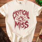 Cream t-shirt with distressed "Critical Miss" text and dice graphic.