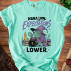 T-shirt with wizard frog and "Mana Low, Expectations Lower" text.