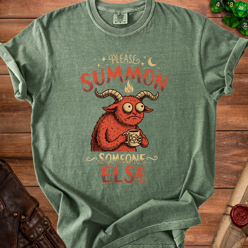 Green t-shirt with a cartoon demon holding a mug that says "Please Summon Someone Else."