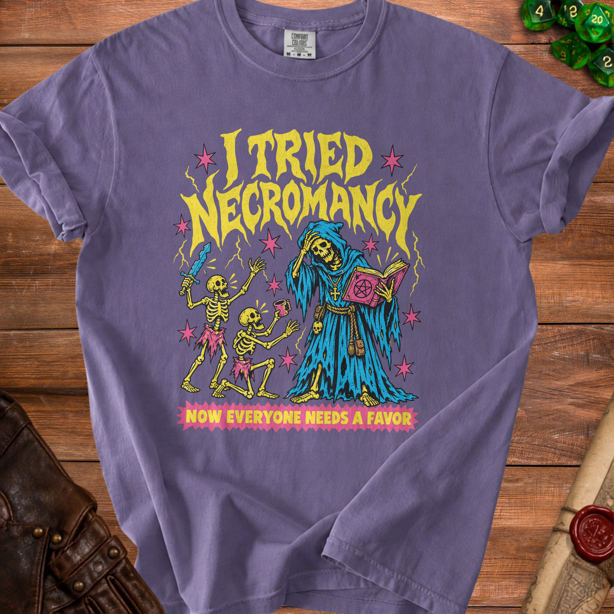 T-shirt graphic with skeletons, grim reaper, and text "I tried necromancy, now everyone needs a favor."