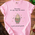 Pink t-shirt with crystals in a pot graphic and text "Remember, the only magic that matters is your personal growth".