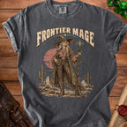 Frontier Mage t-shirt design with a desert landscape and a witch with a staff.