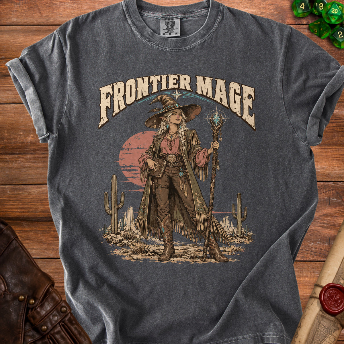 Frontier Mage t-shirt design with a desert landscape and a witch with a staff.