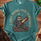 Graphic tee with a menacing sloth holding a bloody chainsaw, surrounded by skulls and flames. Text reads "I ONLY WAKE FOR VENGEANCE".