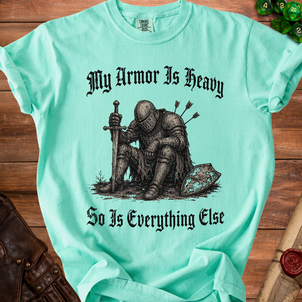 T-shirt with knight sitting, holding sword, and text "My Armor Is Heavy".