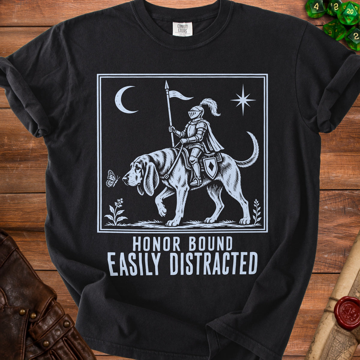 Black t-shirt with white graphic of knight on dog, moon, star, and text.