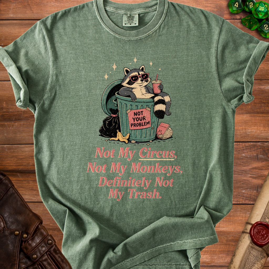Green t-shirt with raccoon in trash can graphic and text: "Not My Circus, Not My Monkeys, Definitely Not My Trash."