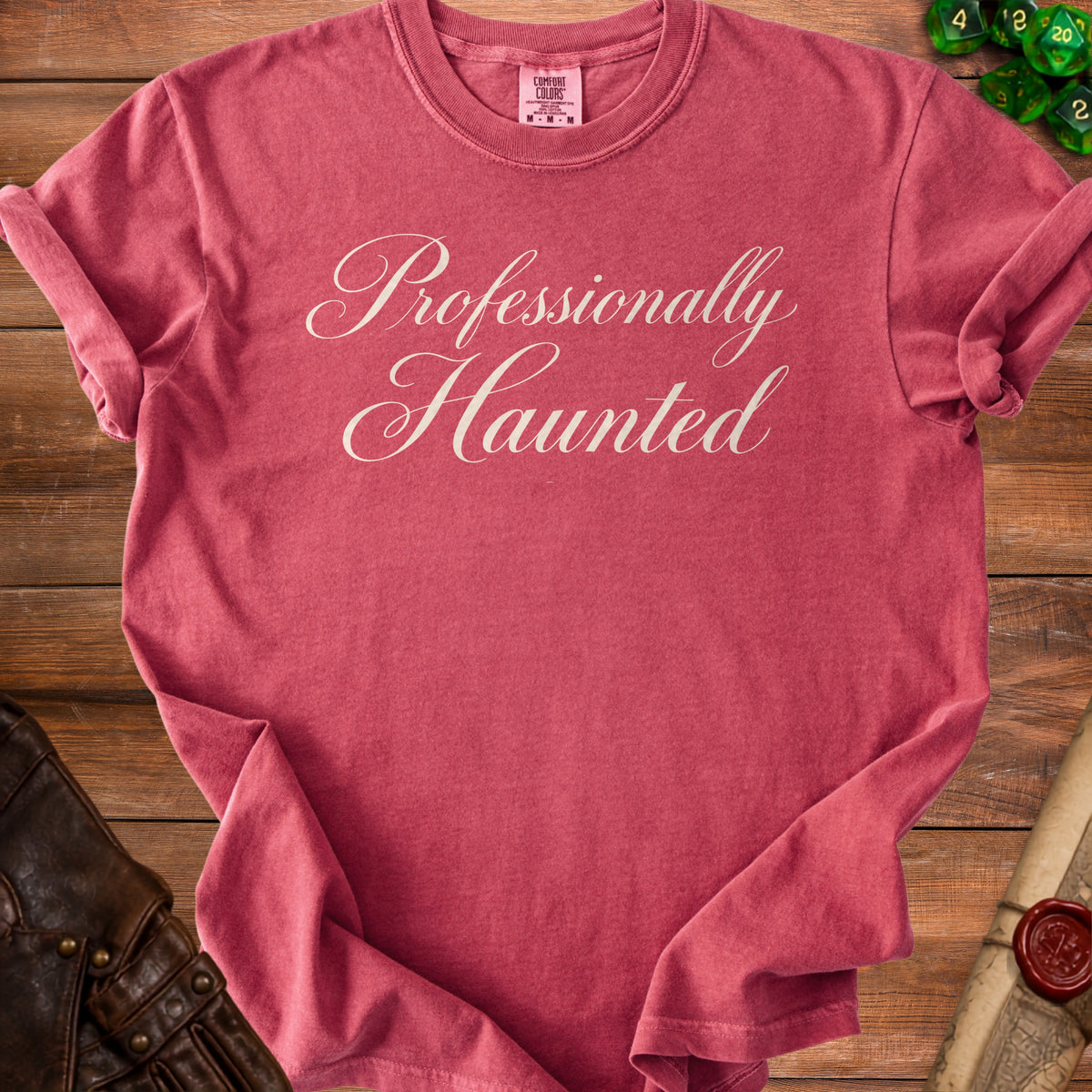 Red t-shirt with "Professionally Haunted" in white cursive text.