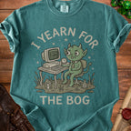 Green creature with horns at a computer on a desk with text I YEARN FOR THE BOG.