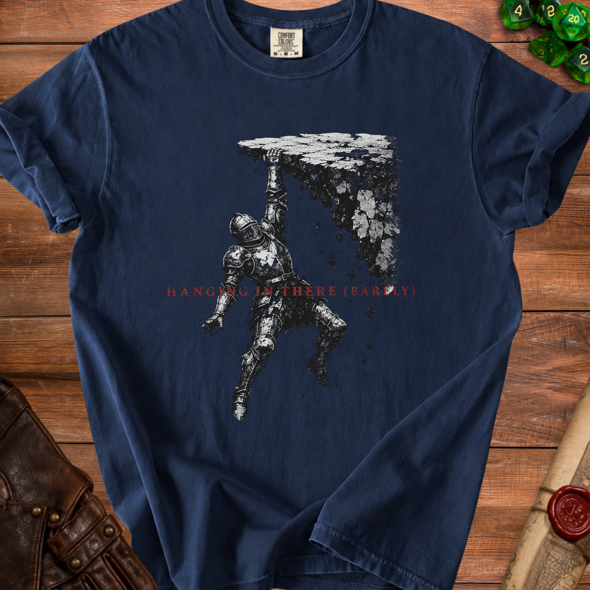 Knight in armor hanging from a crumbling cliff, text "HANGING IN THERE (BARELY)".