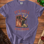 Purple t-shirt with text "IT'S HELL OUT THERE STAY INSIDE" and a demon.
