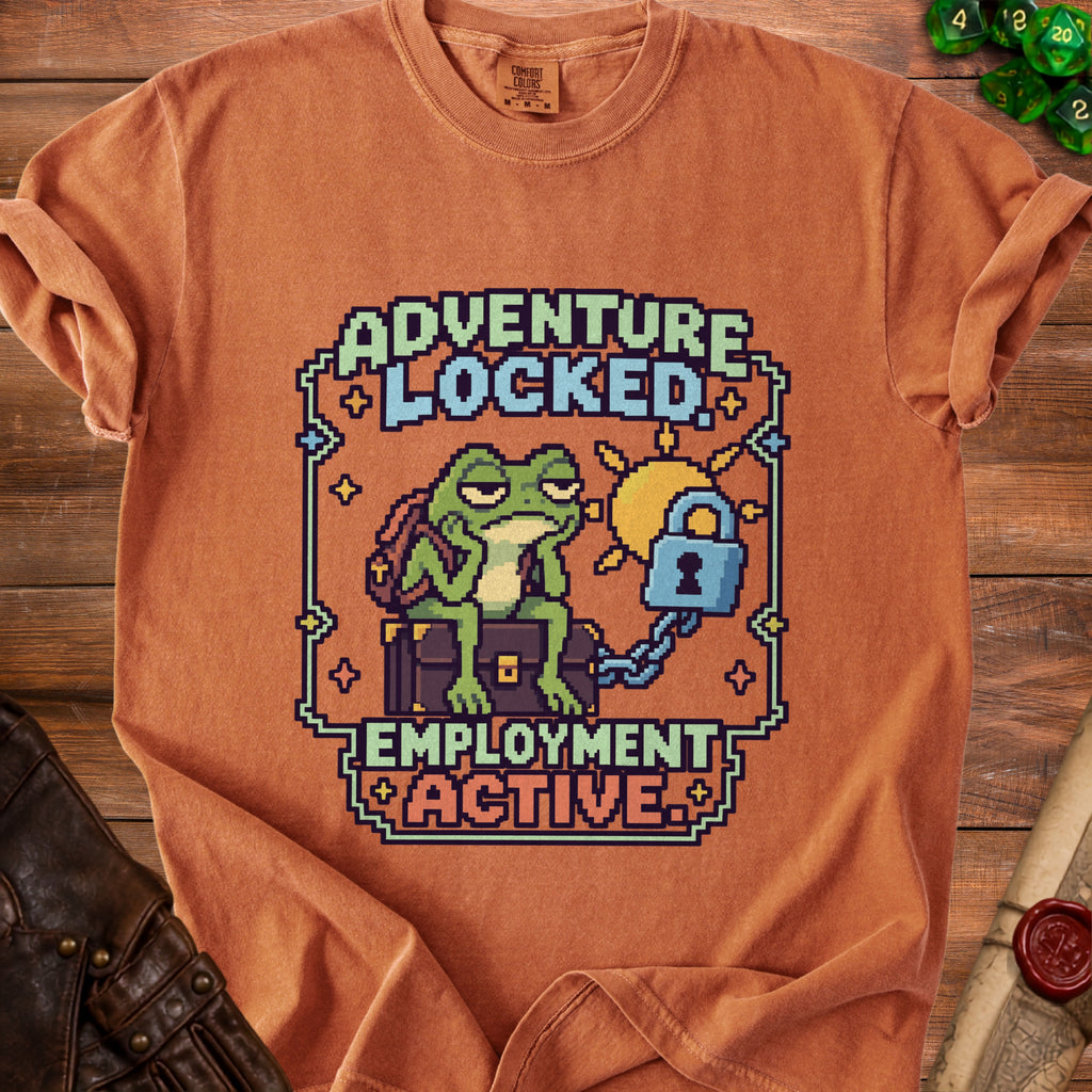 Rust-colored t-shirt featuring pixel art of a bored frog sitting on a locked treasure chest with text.