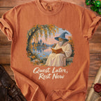 Wizard reading a book by a lake with a castle in the background. Text reads "Quest Later, Rest Now".