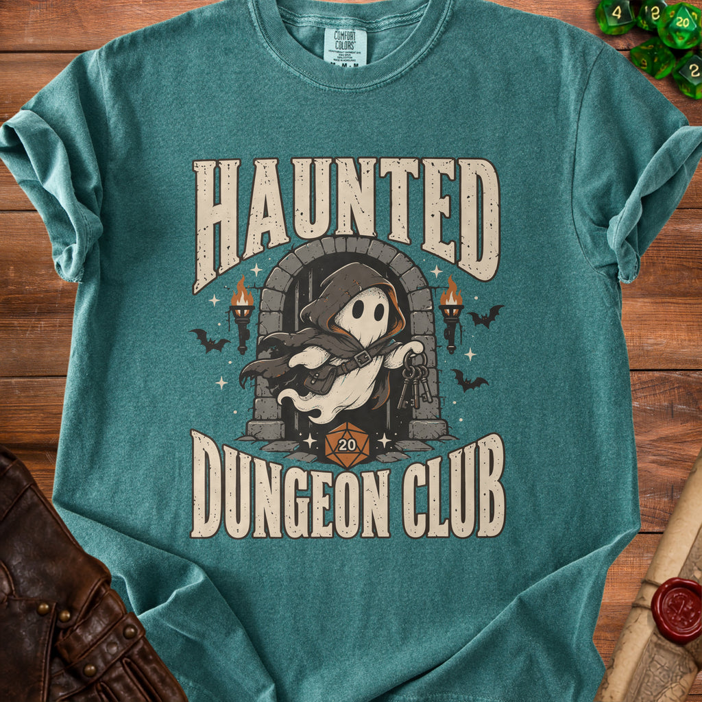 Teal t-shirt featuring a Haunted Dungeon Club graphic of a hooded ghost holding keys in front of a stone archway.