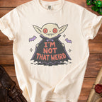 Cream t-shirt with a cartoon vampire graphic that reads "I'm Not That Weird."