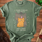 Green t-shirt with cartoon cat wearing a unicorn horn and text.