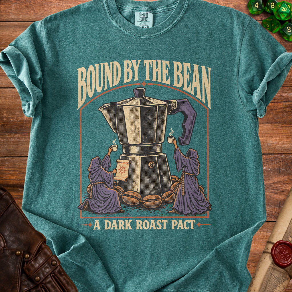 Teal t-shirt with text "BOUND BY THE BEAN" and image of coffee maker, beans, and figures.