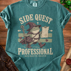 T-shirt with a wizard frog graphic reading "Side Quest Professional" and "Main Objective: Neglected".