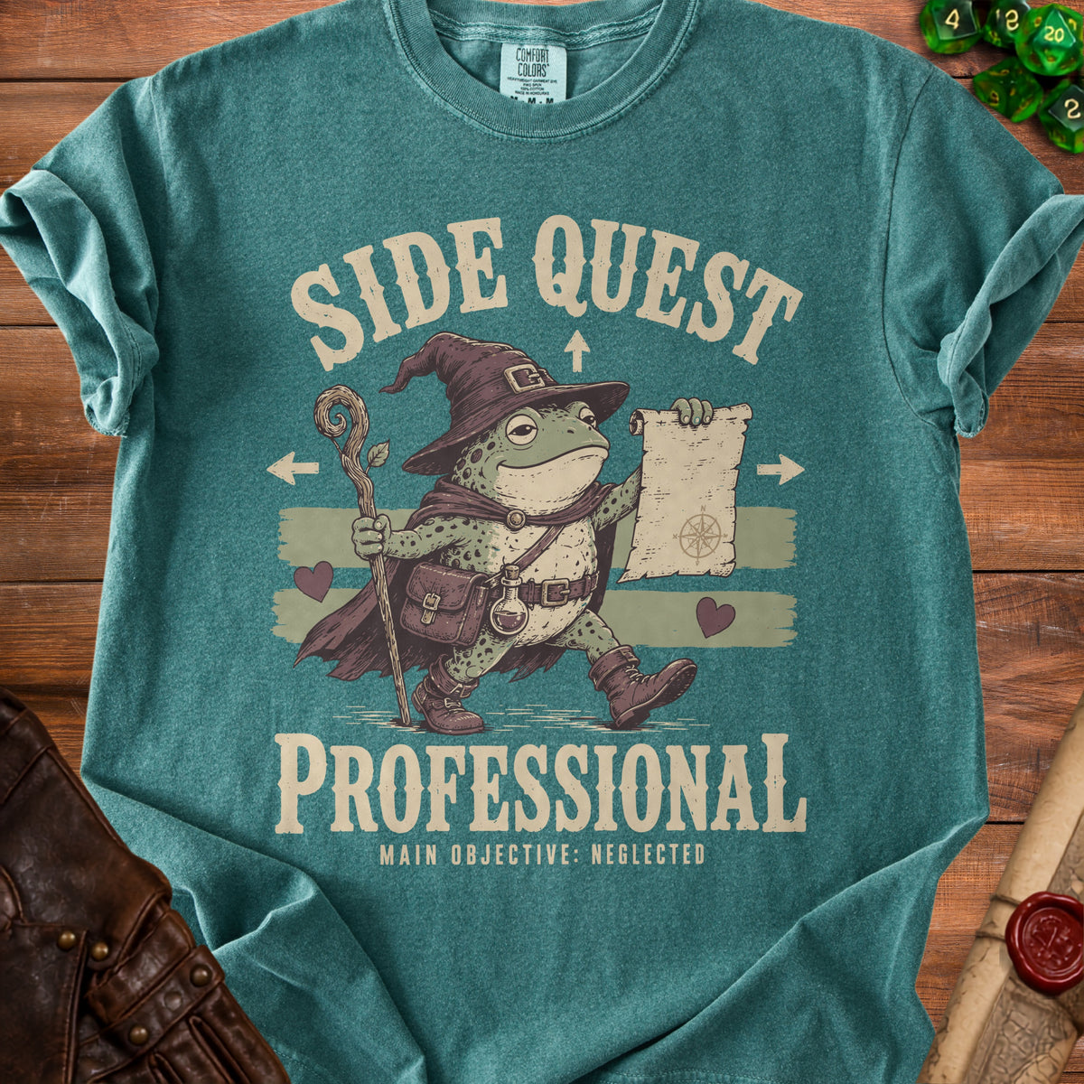 T-shirt with a wizard frog graphic reading "Side Quest Professional" and "Main Objective: Neglected".