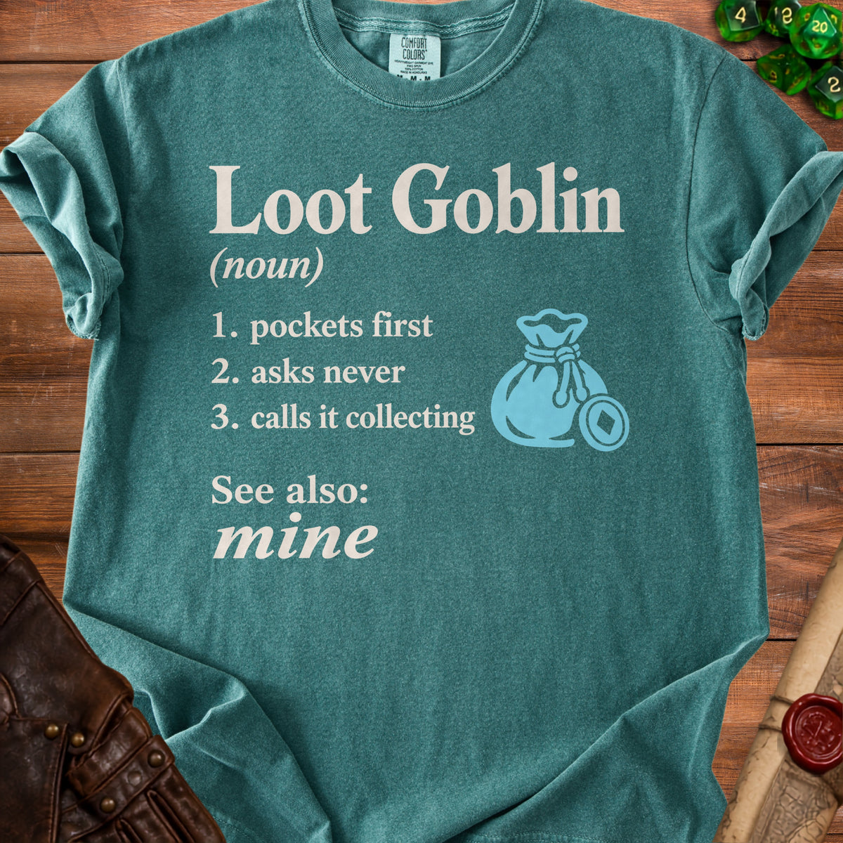 Teal t-shirt with "Loot Goblin (noun): 1. pockets first, 2. asks never, 3. calls it collecting. See also: mine."