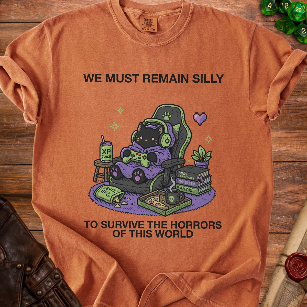 T-shirt with black cat gamer text: We Must Remain Silly to Survive the Horrors of This World.