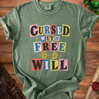 Green t-shirt with "Cursed With Free Will" text and broken compass graphic.