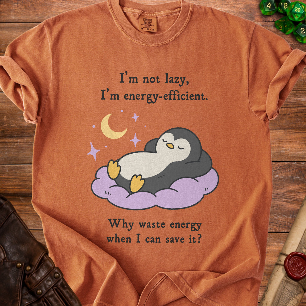Orange t-shirt with a graphic of a sleeping penguin on a cloud and text about energy efficiency.