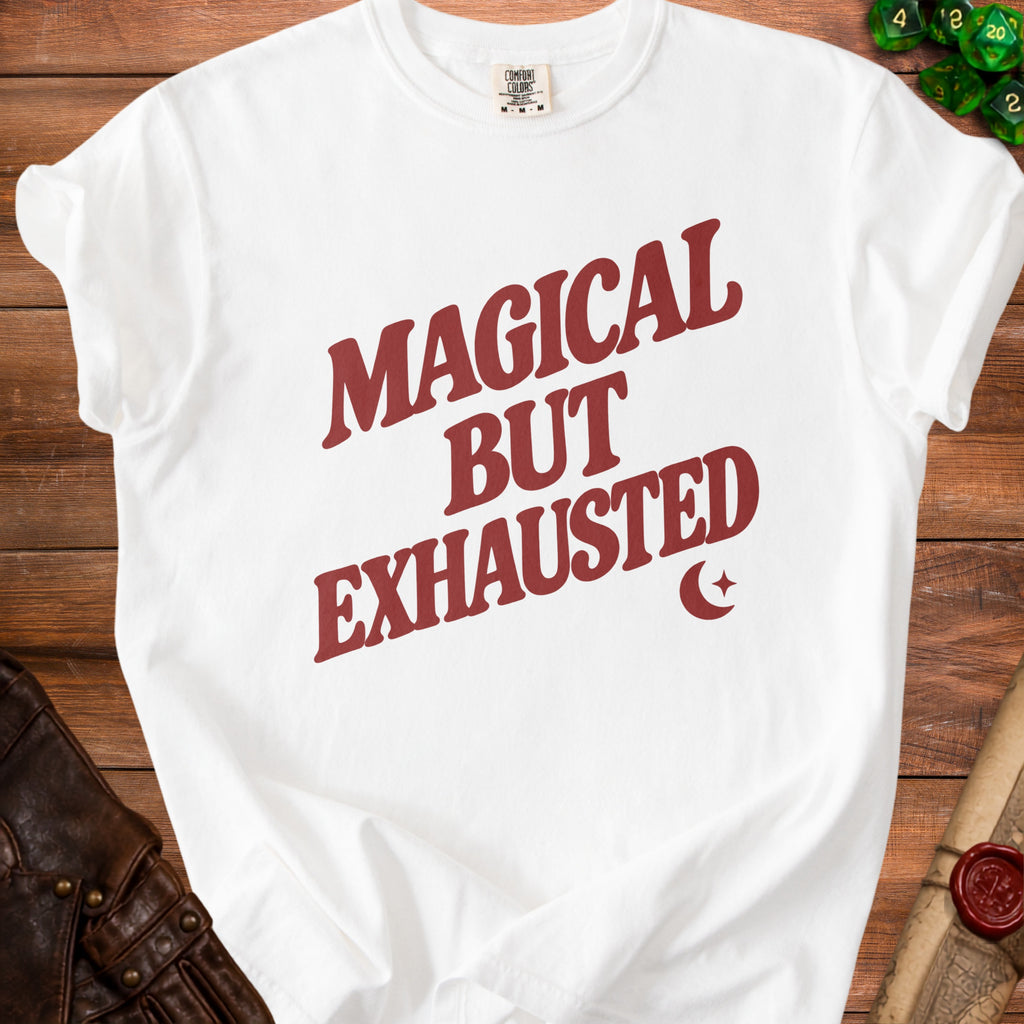 White t-shirt with red text "MAGICAL BUT EXHAUSTED" and crescent moon detail.