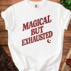 White t-shirt with red text "MAGICAL BUT EXHAUSTED" and crescent moon detail.