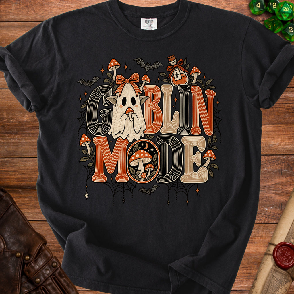 Black t-shirt with "Goblin Mode" text featuring a cute ghost, mushrooms, bats, and potion.