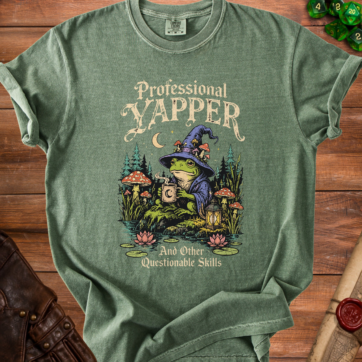 Green t-shirt with wizard frog, mushrooms, moon, and text "Professional Yapper And Other Questionable Skills".