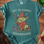 Teal t-shirt with a cartoon goblin holding a skull staff, reading "Off to Commit Shenanigans".