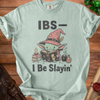 Light blue t-shirt with goblin character reading a book, wearing a witch hat, text reads "IBS- I Be Slain'".
