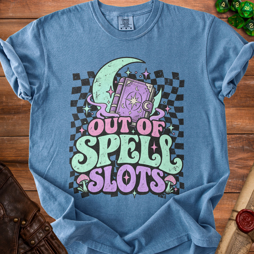 Blue t-shirt with "OUT OF SPELL SLOTS" text, moon, and spellbook graphic.