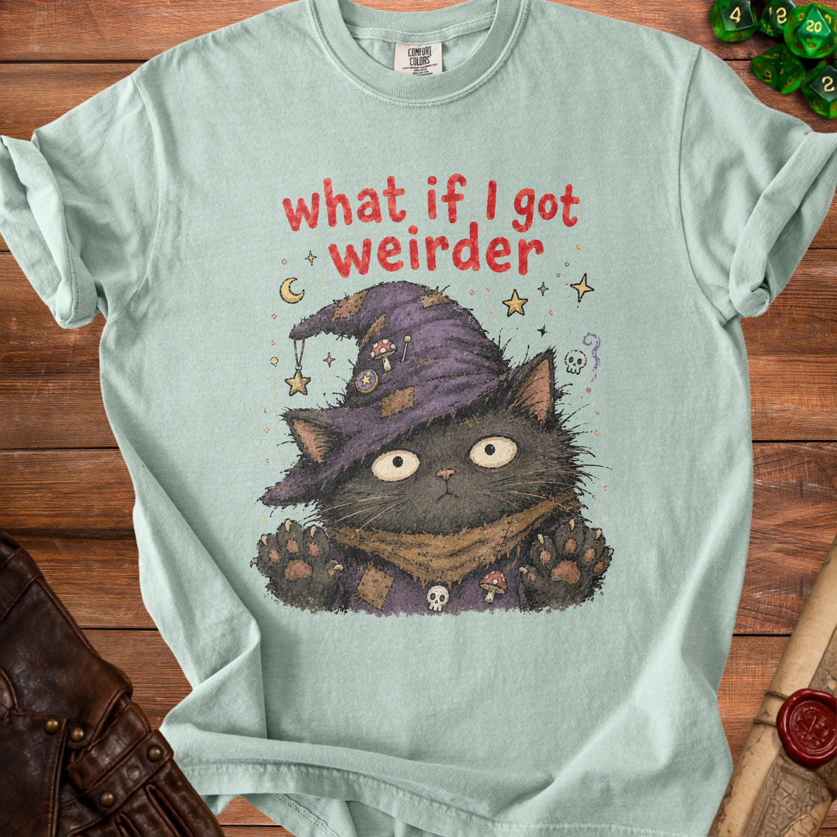 Light blue t-shirt with a black cat wearing a witch hat and the text "what if I got weirder."