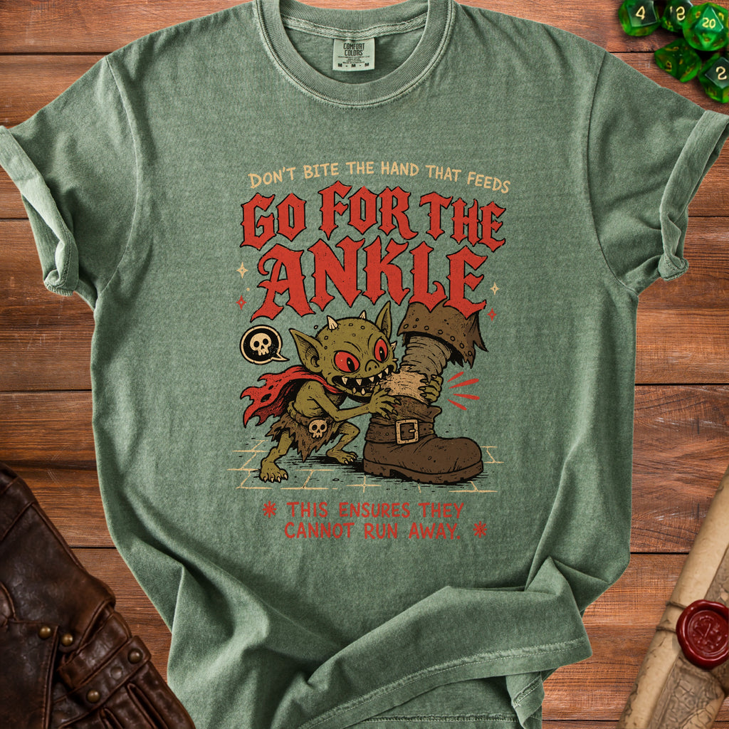 Green t-shirt with goblin biting a boot and text "Go for the ankle".