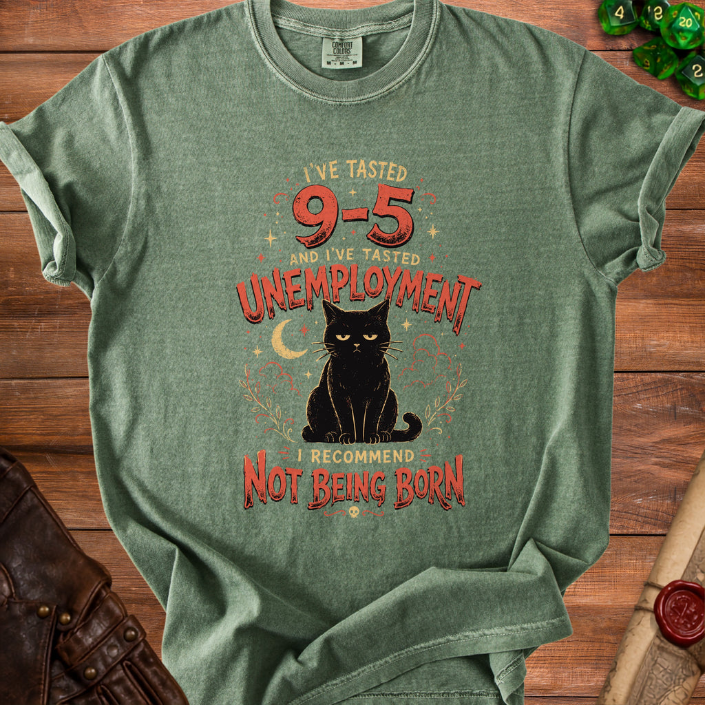 Green t-shirt with black cat graphic and text "I've tasted 9-5 and I've tasted unemployment. I recommend not being born."