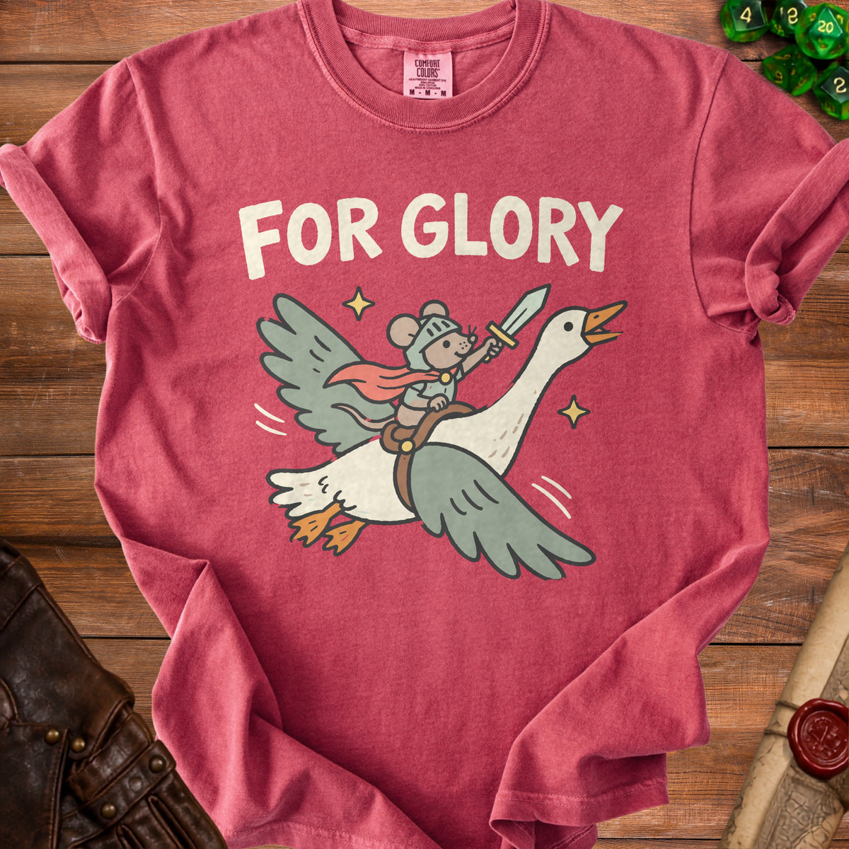 A red t-shirt with a graphic of a mouse knight riding a flying goose holding a sword.