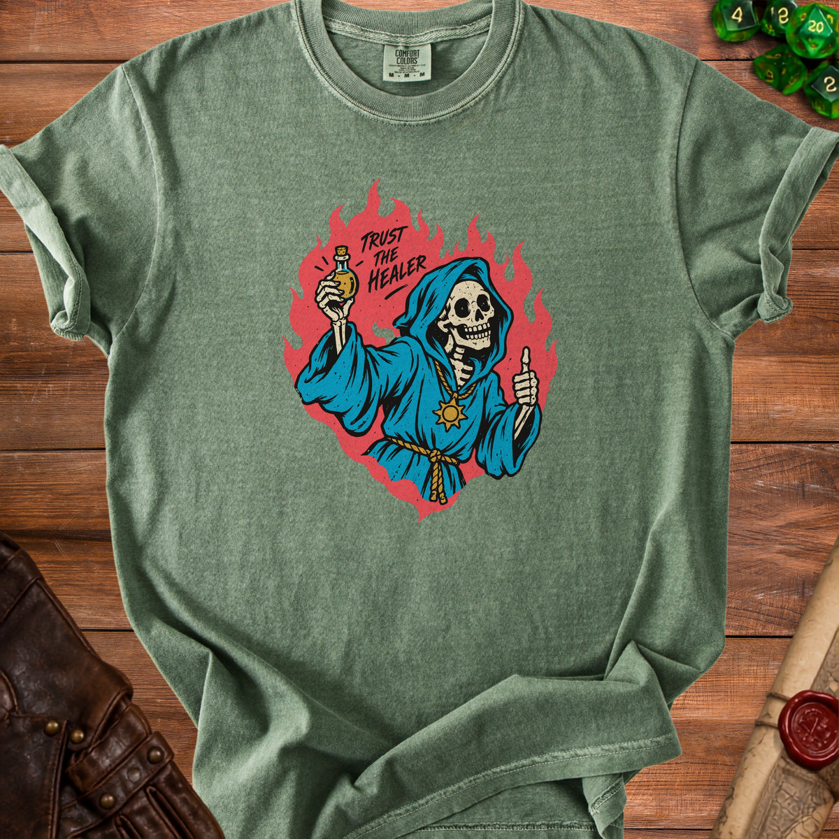 Green t-shirt with skeleton in blue robe holding potion, text "Trust the Healer."